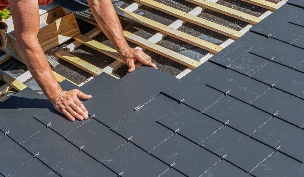 slate roof being placed